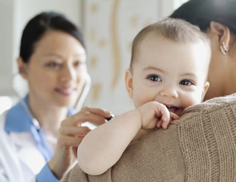 Nurse examining baby