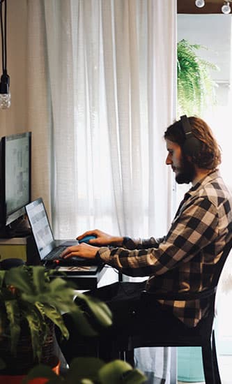 man working on laptop at home