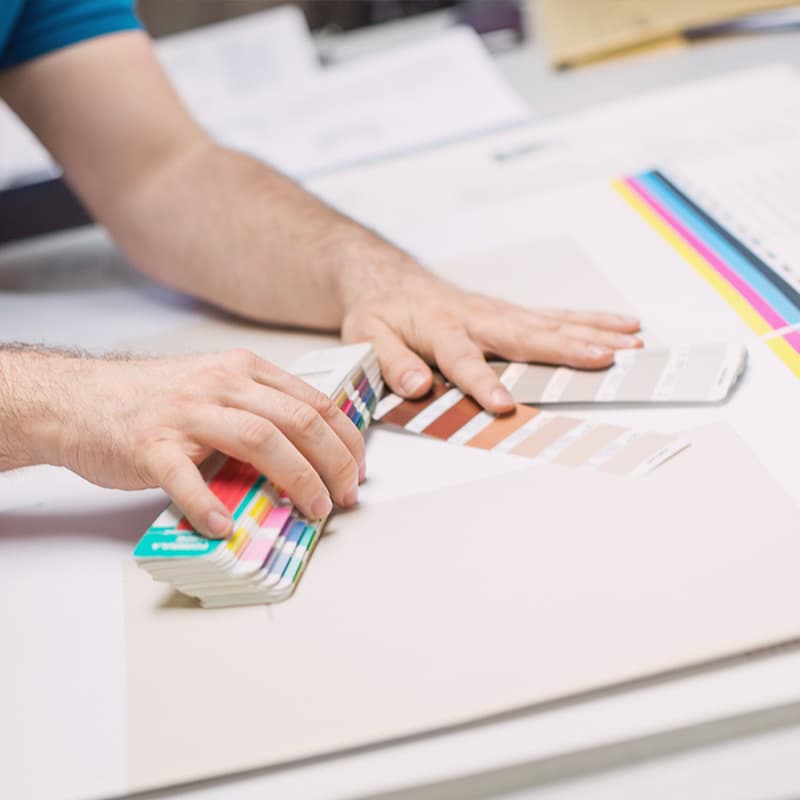 Printing press worker with color swatch