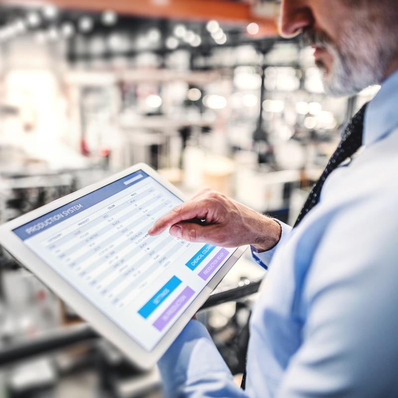 man reviewing data on a mobile tablet