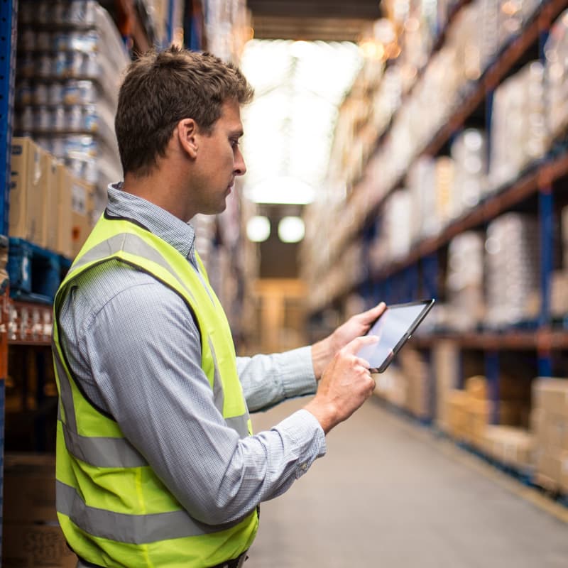 Vested Man in Warehouse