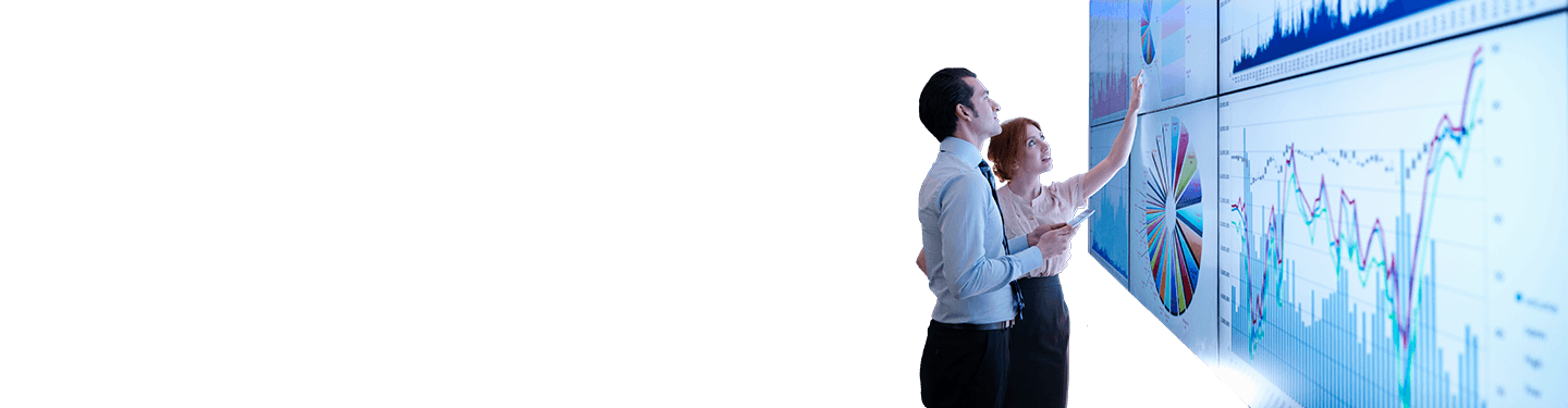 A man and woman looking at a digital report on a projector, demonstrating how the digital workplace has changed.