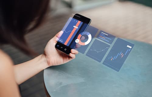 Closeup shot of young businesswoman analysing finance data on smartphone