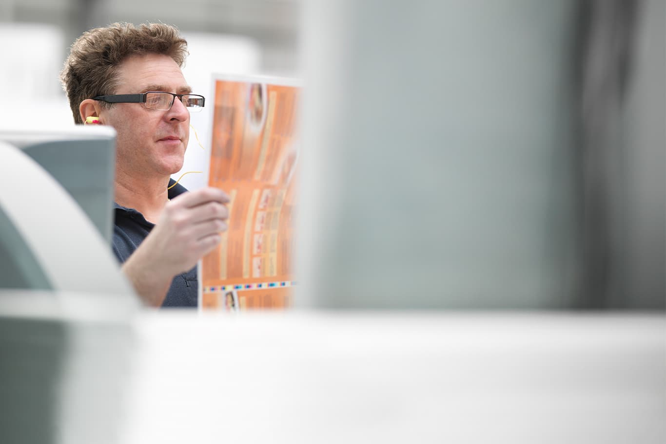 Man looking at printed paper